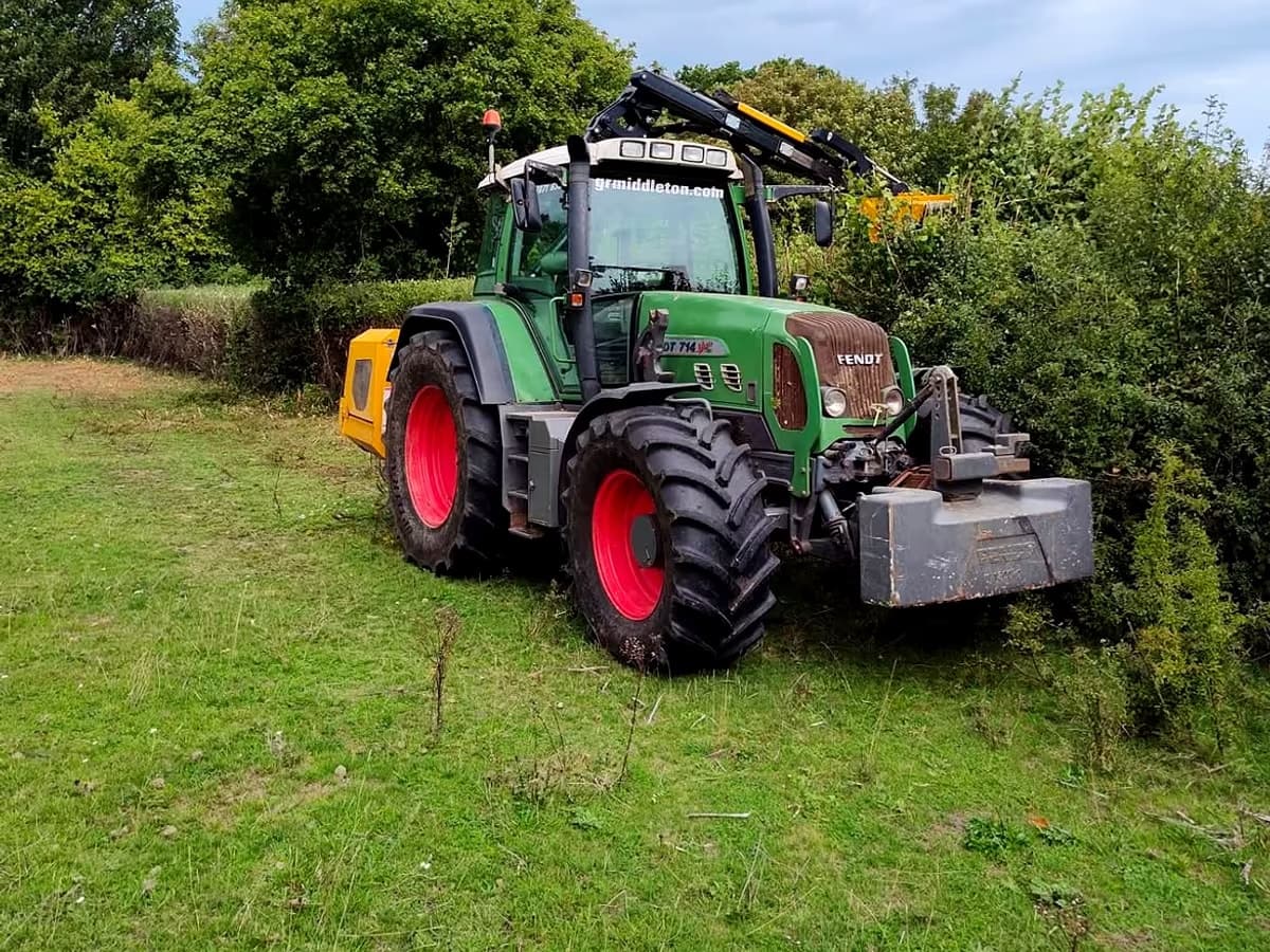 Gabriel's Fendt tractor with a hedge cutter, parked in a field beside a freshly cut hedge